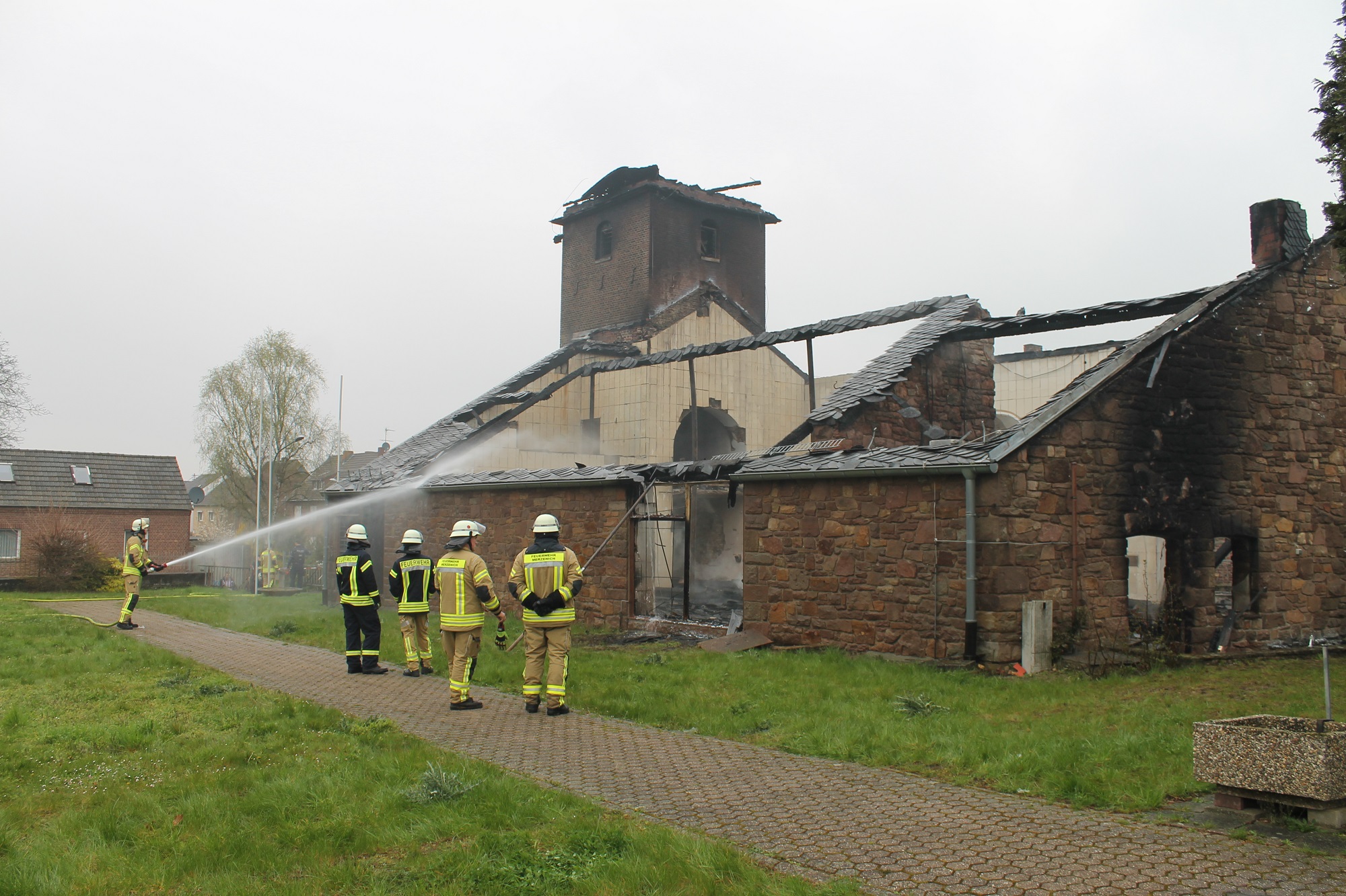 Die Feuerwehr löscht letzte Flammen in der bis auf die Grundmauern niedergebrannten Kirche am 17. April 2023 (Foto: © Bernd Servos).